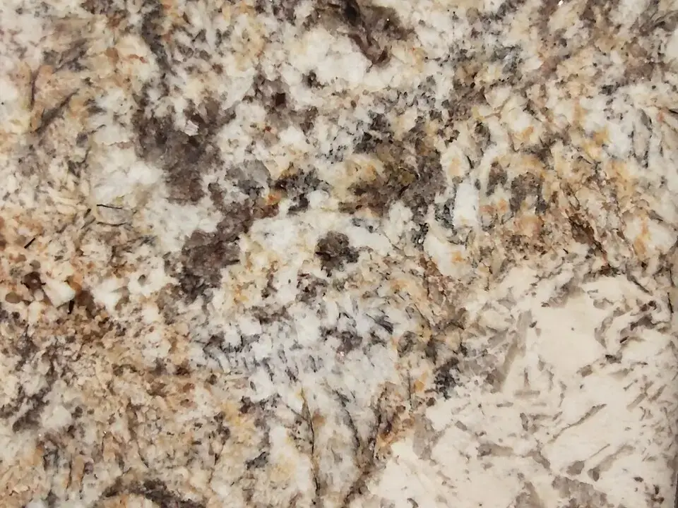 Polished granite slab with gold, grey and brown mineral grain