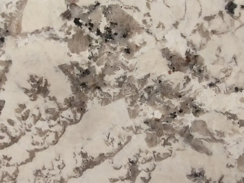 Polished light granite slab with grey and brown grain